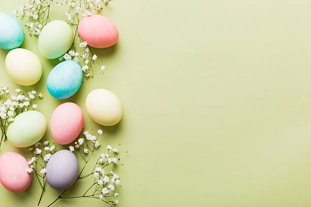 istock Happy Easter composition. Easter eggs on colored table with gypsophila. Natural dyed colorful eggs background top view with copy space 2206956857