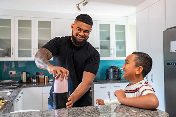 istock Pacific Islander Father and Son Making Lunch in Kitchen 2206956980