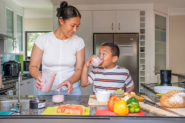 istock Pacific Islander Mother and Son Making Smoothies in Kitchen 2206957007