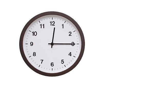 A simple round wall clock with a dark brown frame and a white face displaying 12.15/00.15. Isolated on a white background, perfect for time-related concepts, deadlines, and schedule themes.
