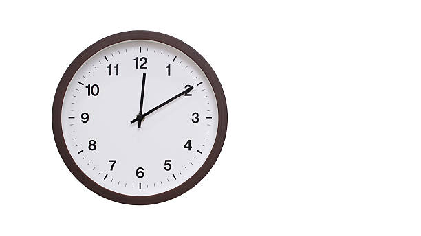 istock A simple round wall clock with a dark brown frame and a white face displaying 12.10/00.10. Isolated on a white background, perfect for time-related concepts, deadlines, and schedule themes. 2206961181