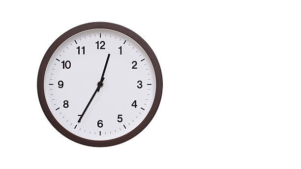 istock A simple round wall clock with a dark brown frame and a white face displaying 00.35/12.35. Isolated on a white background, perfect for time-related concepts, deadlines, and schedule themes. 2206961187
