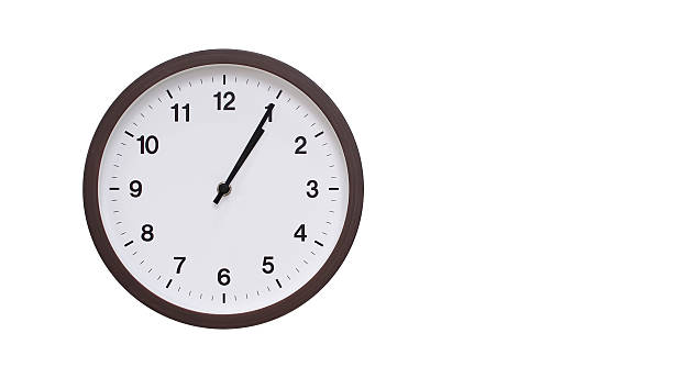istock A simple round wall clock with a dark brown frame and a white face displaying 13.05/01.05. Isolated on a white background, perfect for time-related concepts, deadlines, and schedule themes. 2206961203