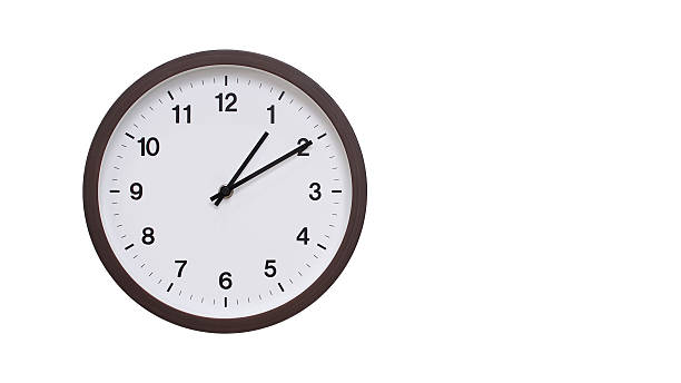 istock A simple round wall clock with a dark brown frame and a white face displaying 13.10/01.10. Isolated on a white background, perfect for time-related concepts, deadlines, and schedule themes. 2206961214