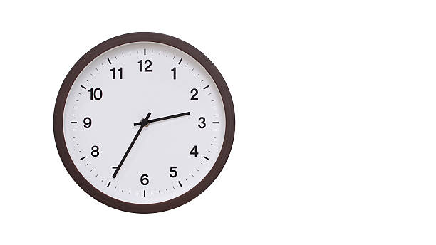 istock A simple round wall clock with a dark brown frame and a white face displaying 14.35/02.35. Isolated on a white background, perfect for time-related concepts, deadlines, and schedule themes. 2206961248