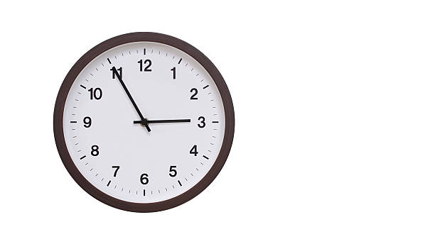 istock A simple round wall clock with a dark brown frame and a white face displaying 14.55/02.55. Isolated on a white background, perfect for time-related concepts, deadlines, and schedule themes. 2206961257
