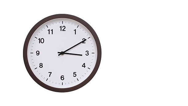 istock A simple round wall clock with a dark brown frame and a white face displaying 15.10/03.10. Isolated on a white background, perfect for time-related concepts, deadlines, and schedule themes. 2206961258