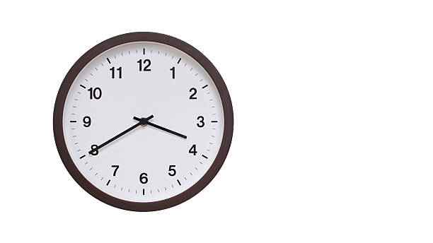 istock A simple round wall clock with a dark brown frame and a white face displaying 15.40/03.40. Isolated on a white background, perfect for time-related concepts, deadlines, and schedule themes. 2206961276