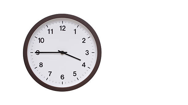 istock A simple round wall clock with a dark brown frame and a white face displaying 15.45/03.45. Isolated on a white background, perfect for time-related concepts, deadlines, and schedule themes. 2206961280