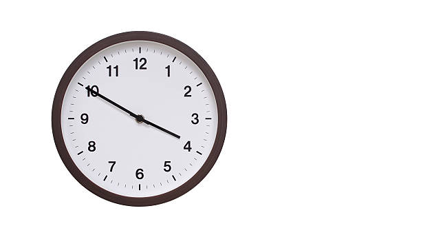 istock A simple round wall clock with a dark brown frame and a white face displaying 15.50/03.50. Isolated on a white background, perfect for time-related concepts, deadlines, and schedule themes. 2206961282