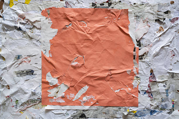istock Torn square orange paper glued on dirty wall 2206961686