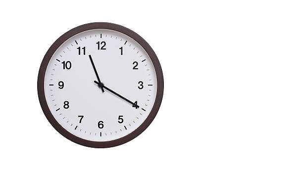 istock A simple round wall clock with a dark brown frame and a white face displaying 11.20/23.20. Isolated on a white background, perfect for time-related concepts, deadlines, and schedule themes. 2206961965