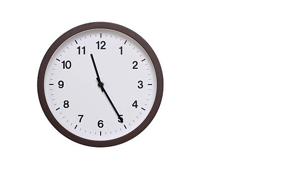 istock A simple round wall clock with a dark brown frame and a white face displaying 11.25/23.25. Isolated on a white background, perfect for time-related concepts, deadlines, and schedule themes. 2206961967
