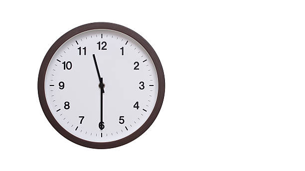 istock A simple round wall clock with a dark brown frame and a white face displaying 11.30/23.30. Isolated on a white background, perfect for time-related concepts, deadlines, and schedule themes. 2206961973