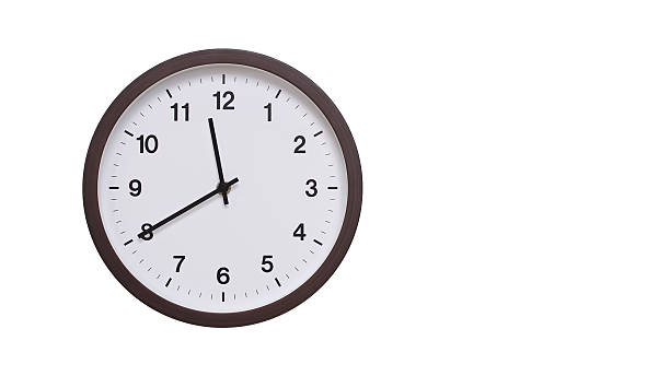 istock A simple round wall clock with a dark brown frame and a white face displaying 11.40/23.40. Isolated on a white background, perfect for time-related concepts, deadlines, and schedule themes. 2206961989