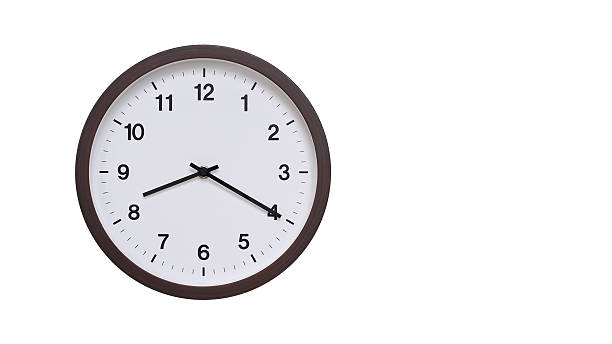 istock A simple round wall clock with a dark brown frame and a white face displaying 20.20/08.20. Isolated on a white background, perfect for time-related concepts, deadlines, and schedule themes. 2206962003