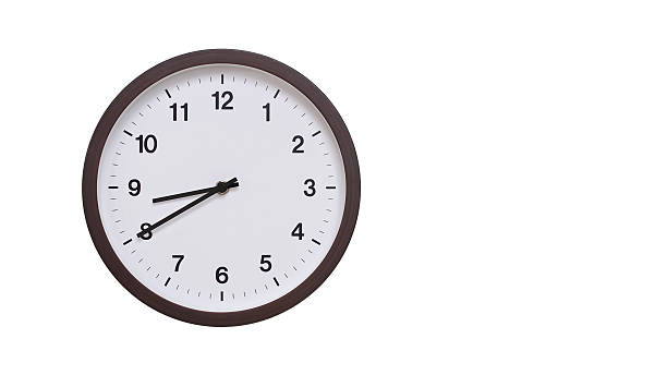 istock A simple round wall clock with a dark brown frame and a white face displaying 20.40/08.40. Isolated on a white background, perfect for time-related concepts, deadlines, and schedule themes. 2206962049