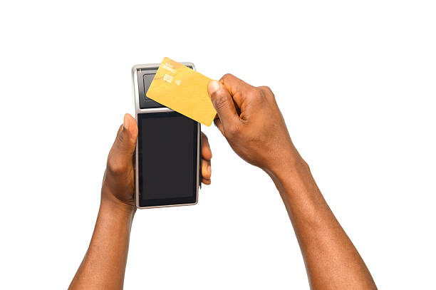 istock Person Tapping Yellow Debit Card on POS Terminal for Contactless Payment 2206962065