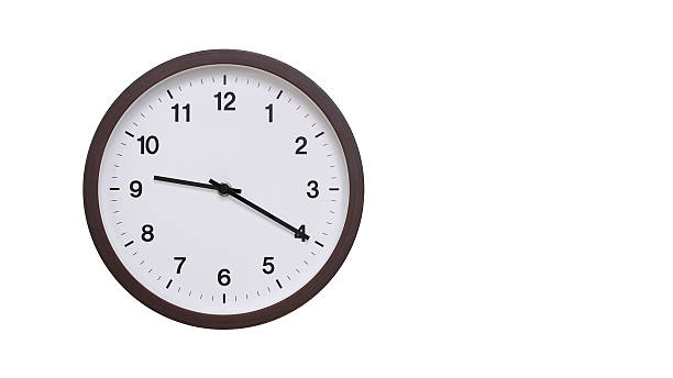 istock A simple round wall clock with a dark brown frame and a white face displaying 21.20/09.20. Isolated on a white background, perfect for time-related concepts, deadlines, and schedule themes. 2206962087