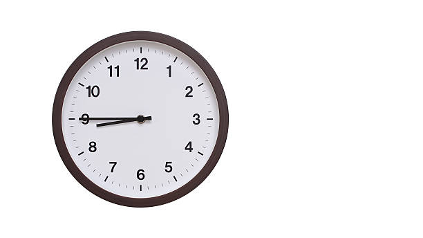 istock A simple round wall clock with a dark brown frame and a white face displaying 20.45/08.45. Isolated on a white background, perfect for time-related concepts, deadlines, and schedule themes. 2206962103