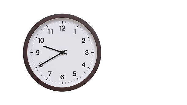 istock A simple round wall clock with a dark brown frame and a white face displaying 21.40/09.40. Isolated on a white background, perfect for time-related concepts, deadlines, and schedule themes. 2206962104