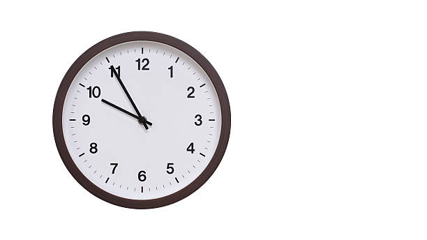 istock A simple round wall clock with a dark brown frame and a white face displaying 21.55/09.55. Isolated on a white background, perfect for time-related concepts, deadlines, and schedule themes. 2206962152