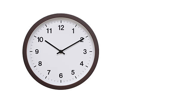 istock A simple round wall clock with a dark brown frame and a white face displaying 22.10/10.10. Isolated on a white background, perfect for time-related concepts, deadlines, and schedule themes. 2206962153
