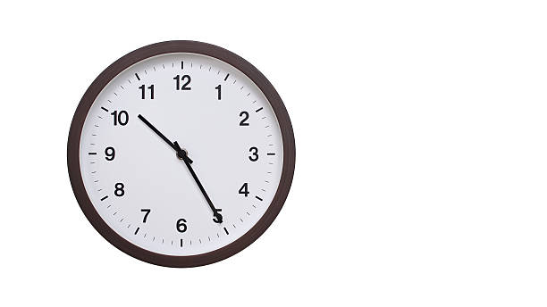 istock A simple round wall clock with a dark brown frame and a white face displaying 22.25/10.25. Isolated on a white background, perfect for time-related concepts, deadlines, and schedule themes. 2206962164
