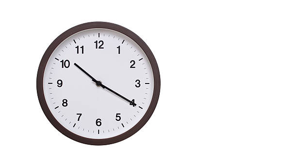 istock A simple round wall clock with a dark brown frame and a white face displaying 22.20/10.20. Isolated on a white background, perfect for time-related concepts, deadlines, and schedule themes. 2206962174