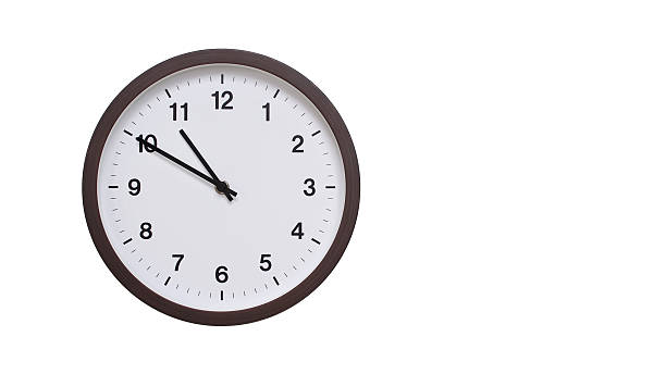 istock A simple round wall clock with a dark brown frame and a white face displaying 10.50/22.50. Isolated on a white background, perfect for time-related concepts, deadlines, and schedule themes. 2206962177