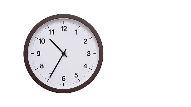 istock A simple round wall clock with a dark brown frame and a white face displaying 10.35/22.35. Isolated on a white background, perfect for time-related concepts, deadlines, and schedule themes. 2206962182