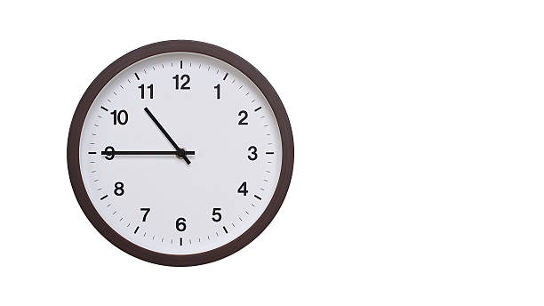 istock A simple round wall clock with a dark brown frame and a white face displaying 10.45/22.45. Isolated on a white background, perfect for time-related concepts, deadlines, and schedule themes. 2206962190