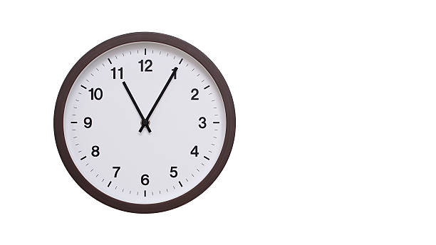 istock A simple round wall clock with a dark brown frame and a white face displaying 11.05/23.05. Isolated on a white background, perfect for time-related concepts, deadlines, and schedule themes. 2206962196