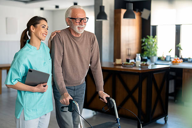 istock Supportive Female Physiotherapist Helping Elderly Male Patient with Walker 2206964784