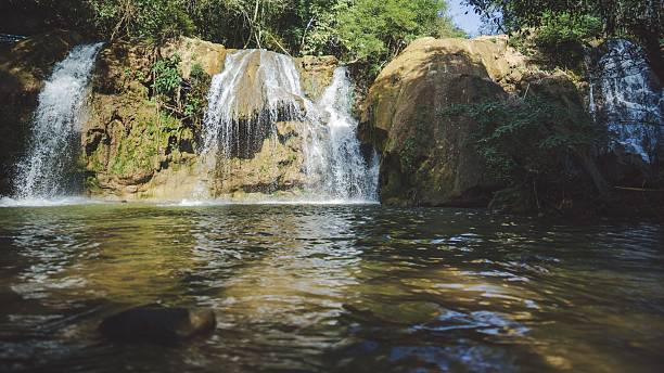 istock A serene waterfall cascading into a clear pool, surrounded by lush greenery and rocky formations, in Tak Thailand. 2206969378