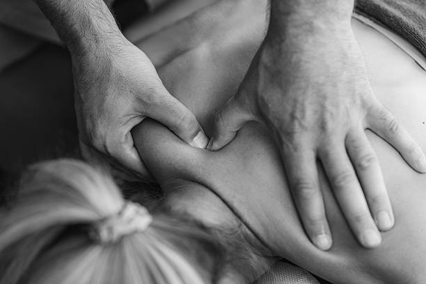istock Physical therapist performs a deep tissue massage on a patients shoulder to relieve muscle tension and improve mobility in a therapeutic setting 2206970201