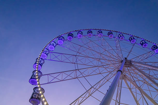 istock Illuminated Ferris wheel at dusk 2206970278