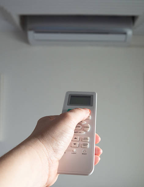 istock Person using remote control to turn on air conditioner 2206972080
