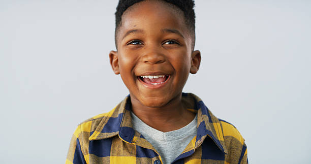 istock Boy, child and happy with face in studio, elementary school student excited and ready for education. African kid, smile and cool confidence for growth, youth space and learner on white background 2206972829