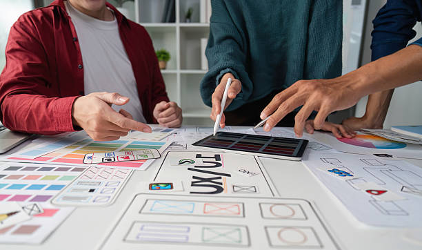 istock Hands-on Collaboration in Digital Design. Team members actively discuss design elements on a digital tablet. 2206974302