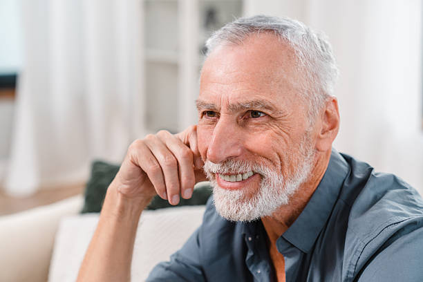 istock Handsome Senior Man Smiling Thoughtfully While Relaxing Indoors 2206974349