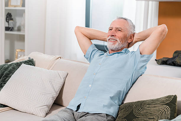 istock Relaxed Senior Man Enjoying Leisure Time at Home on a Comfortable Couch 2206974386