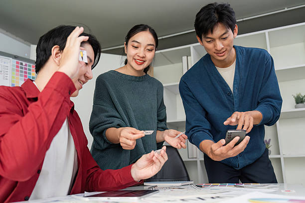 istock Collaborative Design Review. Team members actively sharing design pieces and ideas while analyzing user experience. 2206974788