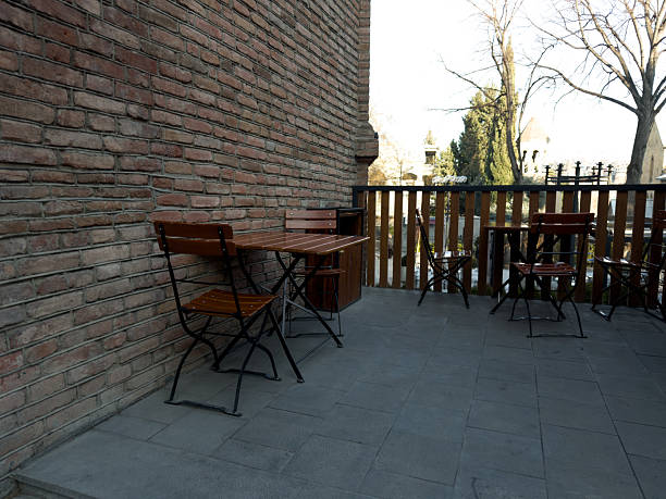 City cafe on street with wooden chairs and tables