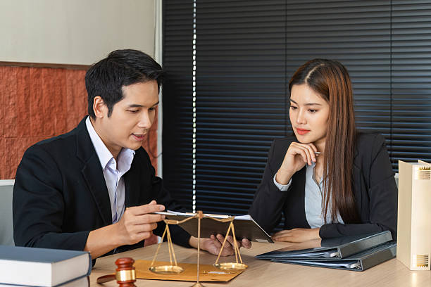 istock Lawyering and Client Communication. A lawyer guiding a client through legal options using a tablet. 2206975667