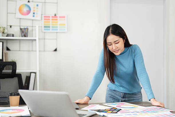 istock Concept Development and Color Analysis. A designer examining color charts and reflecting on project details. 2206976725