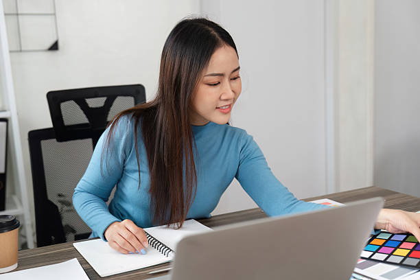 istock Design and Color Coordination. A designer working on color palettes while engaged in digital design tasks. 2206977676