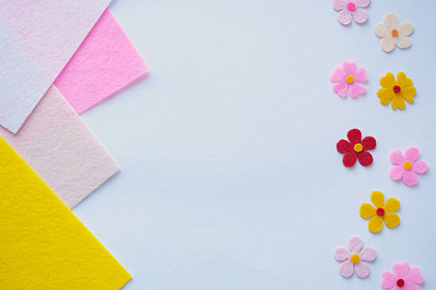 istock Handmade felt flowers on pastel background, DIY craft materials, creative sewing, colorful fabric petals, floral design, soft texture, home decoration idea, artistic composition 2206979034