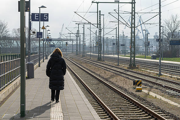 istock Rear view of a woman on a train platform 2206980634