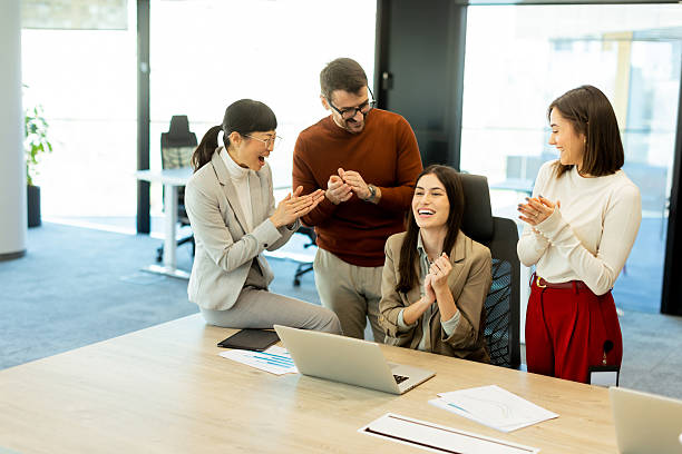 istock Team celebrates success together in a bright modern office environment 2206982447